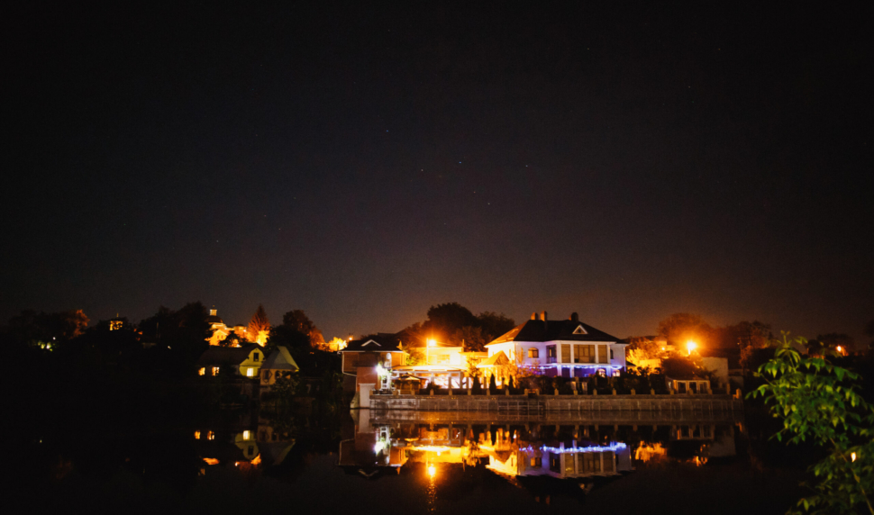 illumination of night wedding celebration near the lake